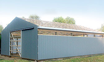 blue metal barn in the process of being built