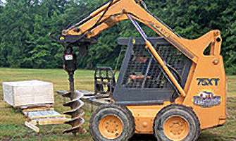 skid loader drilling into the ground