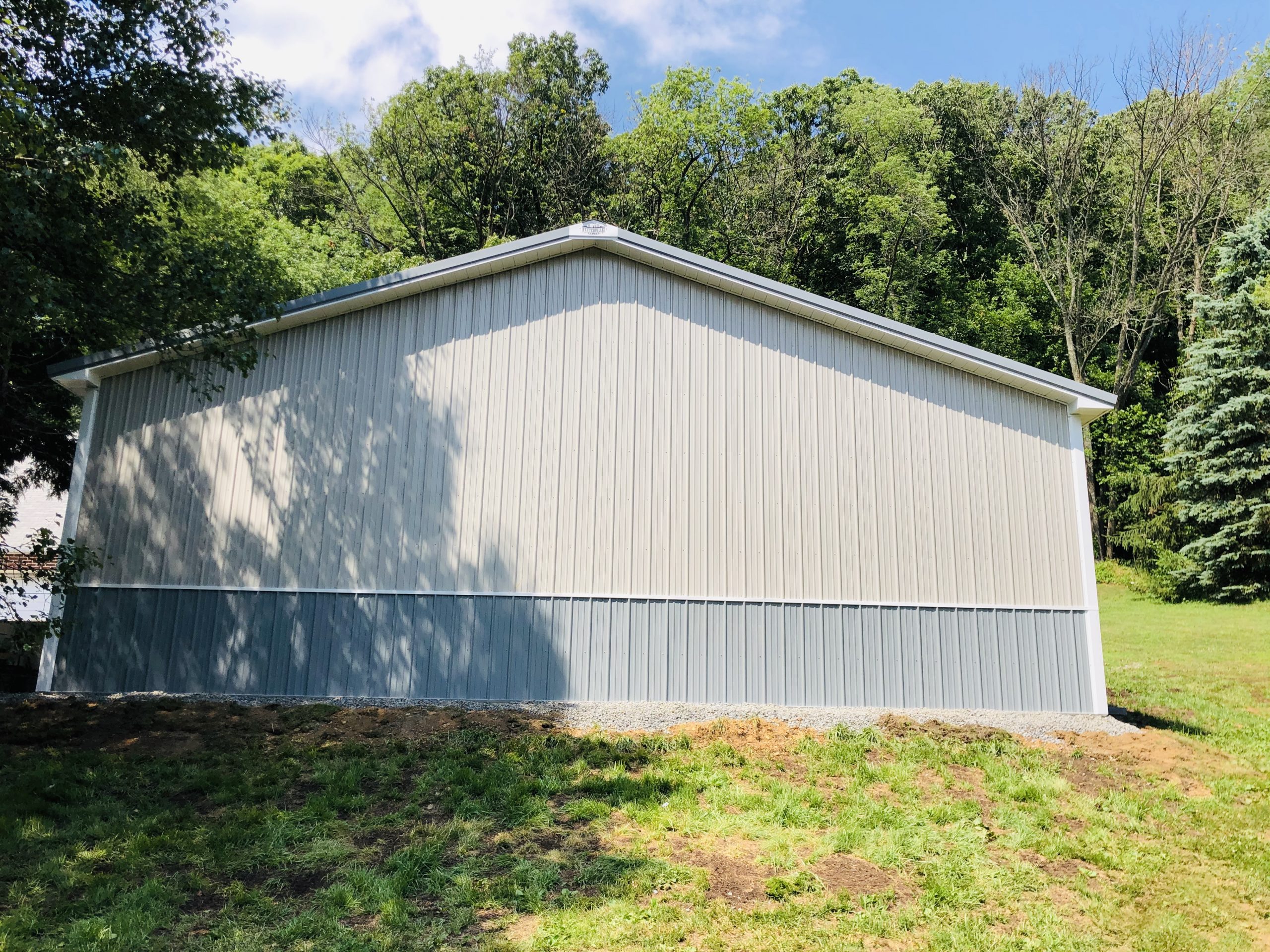 white and blue metal siding on new pole building