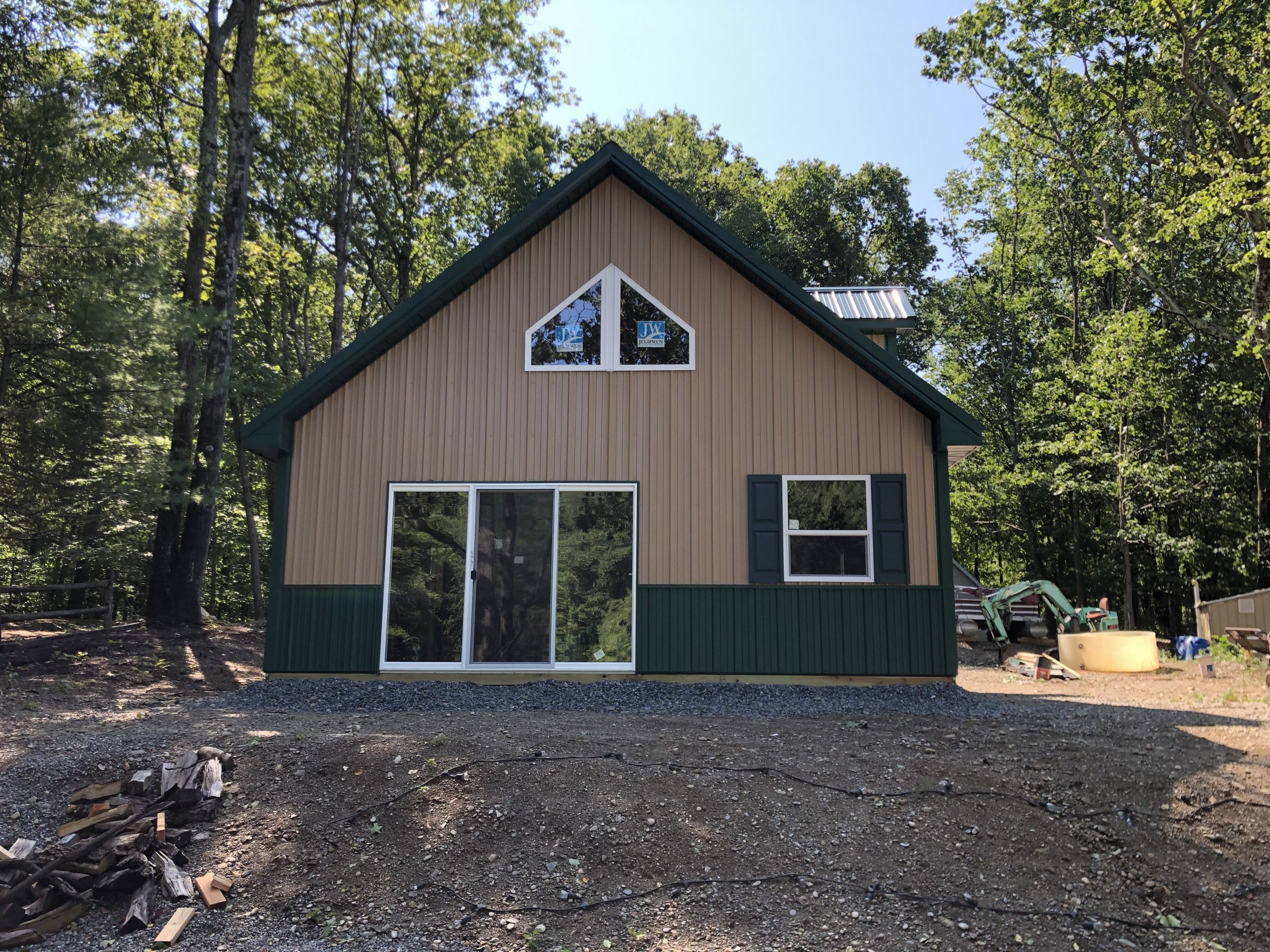 green and tan new pole barn home