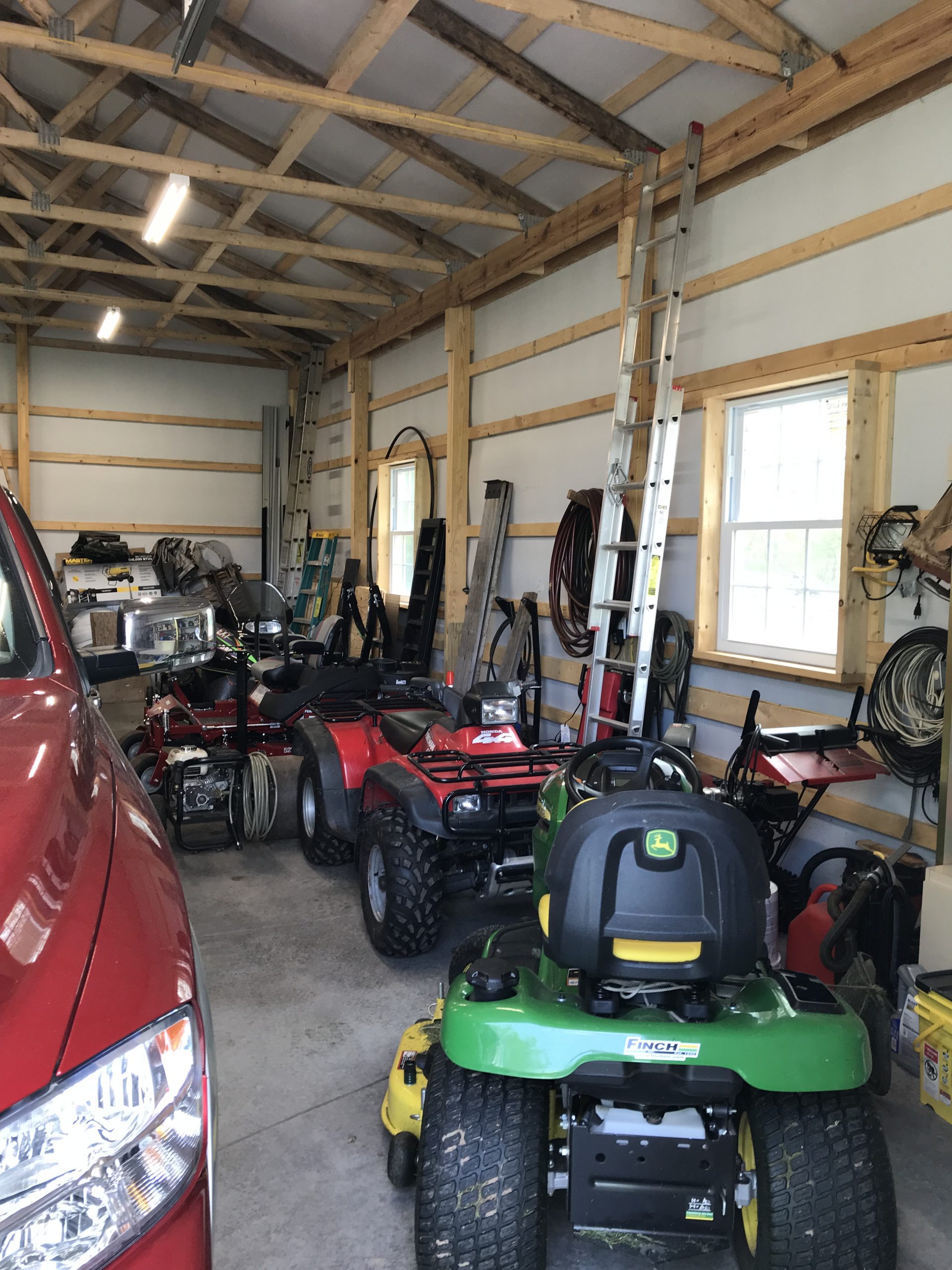 lawn mowers and lawn equipment in pole garage