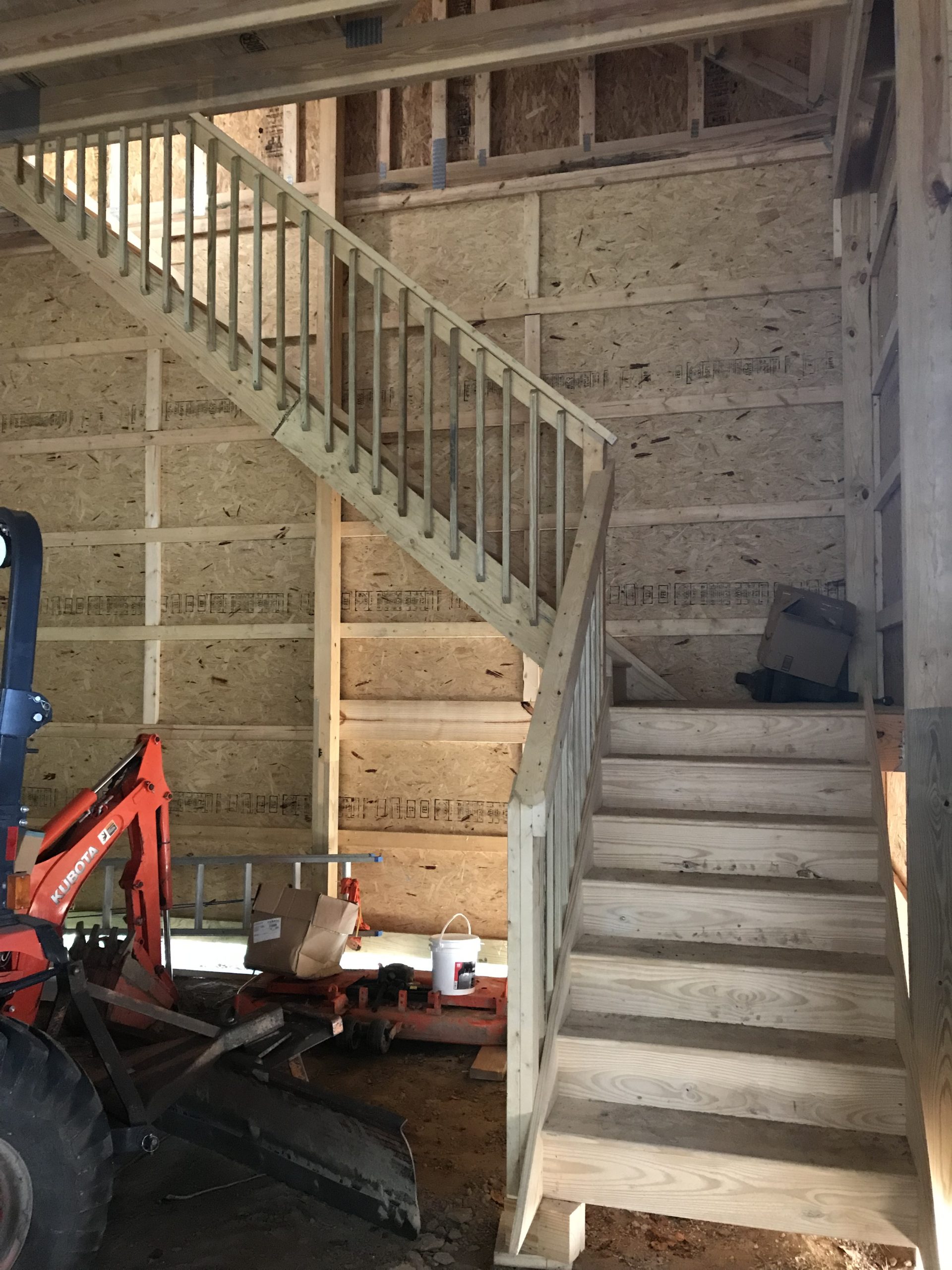 wooden staircase in post-frame garage