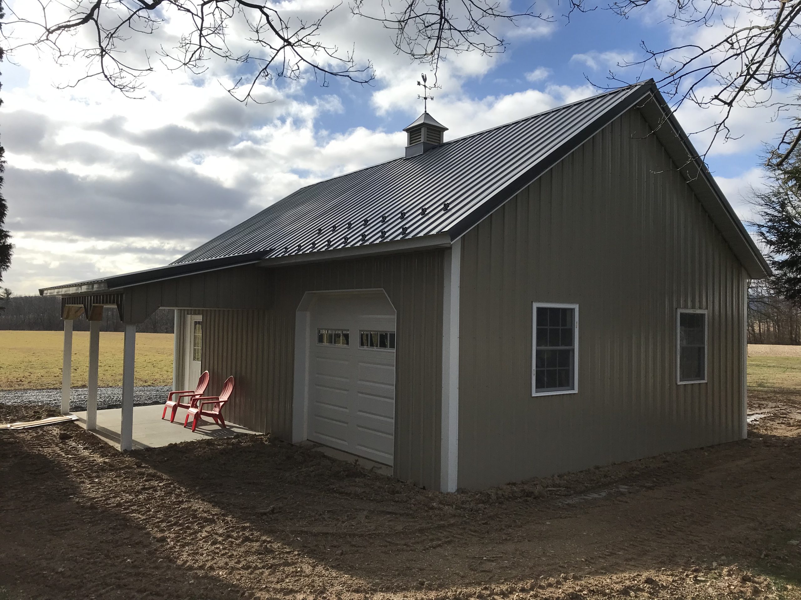 new a-frame residential pole garage with small attached porch