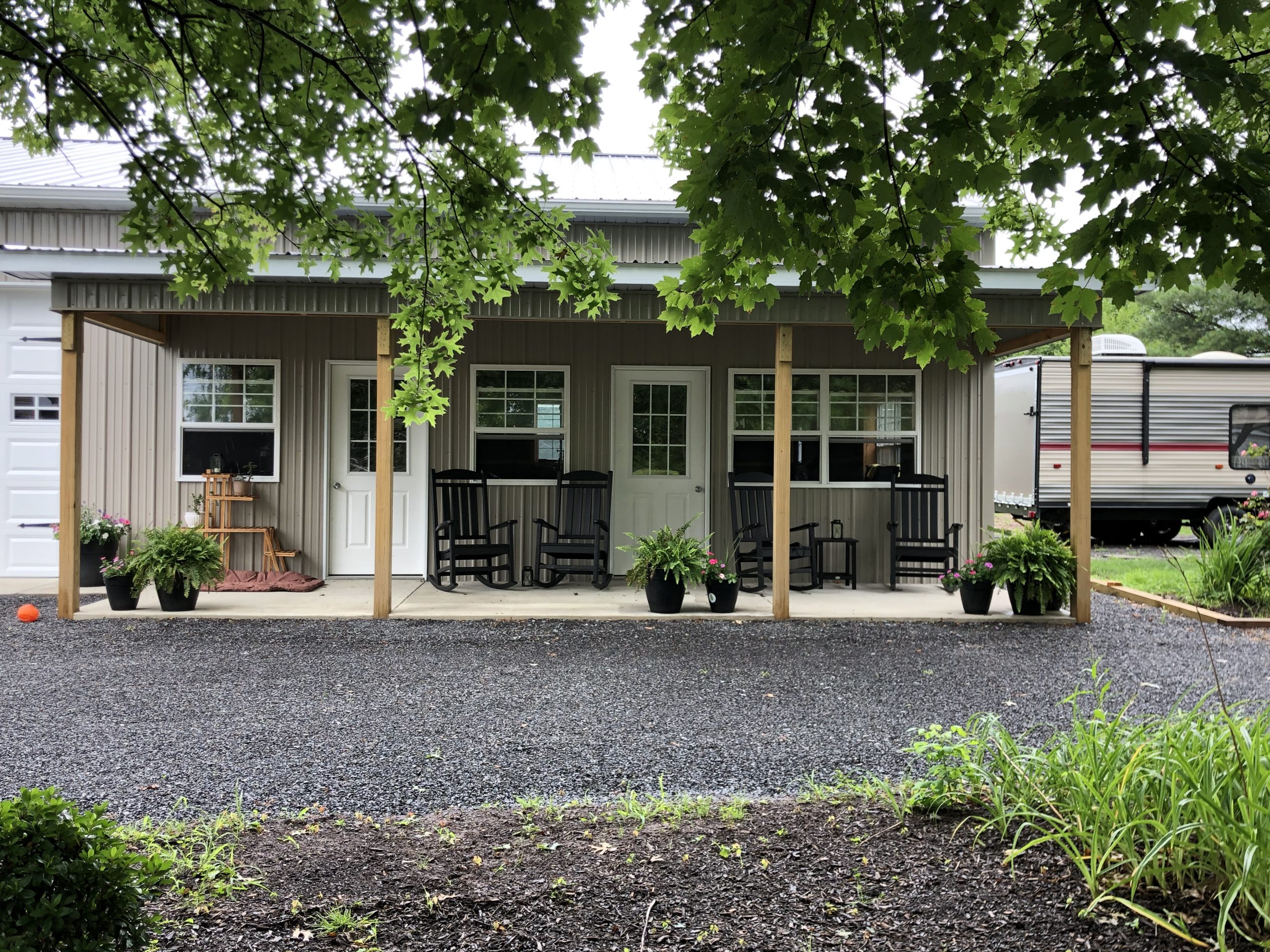 small residential pole building with porch and overhangs