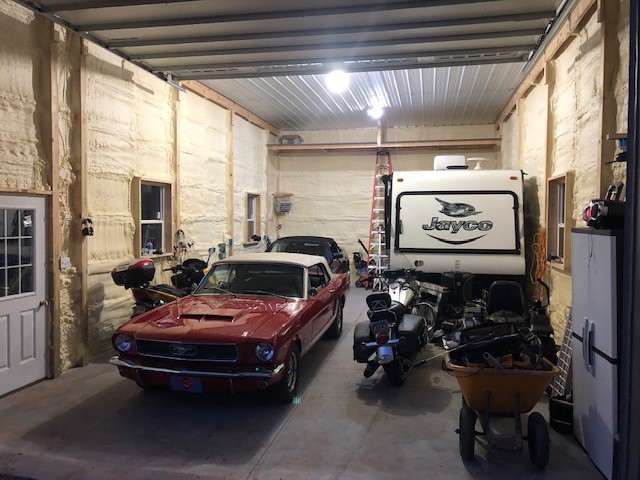 car and equipment in pole barn garage