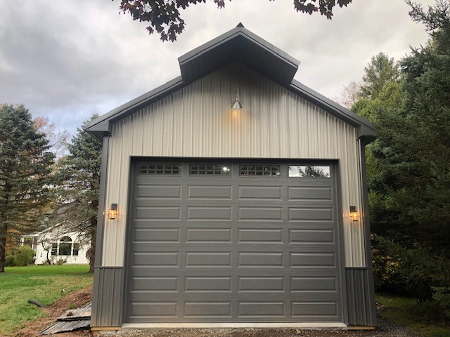 new one car pole garage with metal siding and roofing