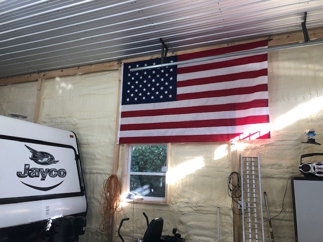 American flag hung in pole barn garage