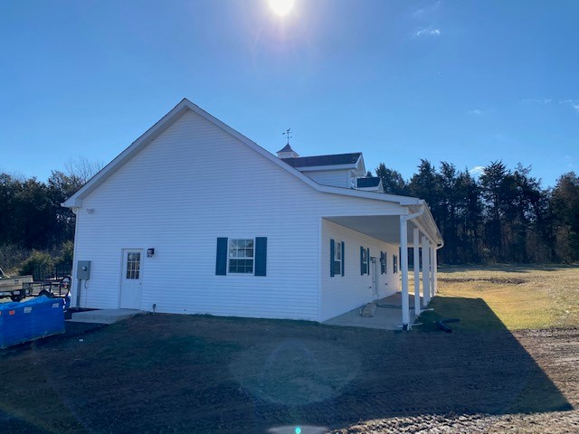 pole barn garage with asphalt shingle roof