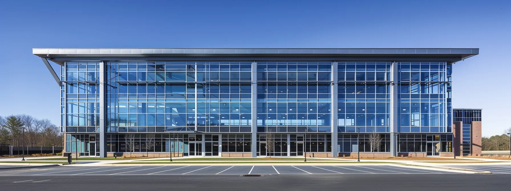 a spacious, modern pole building under a clear blue sky, with large windows and a sleek design, showcasing the top benefits of this building choice for your next project.